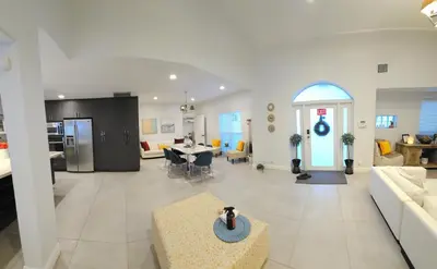 a large living room with a kitchen and a dining room at Beachside Bliss Pool Retreat Half mile to Beach in Hollywood