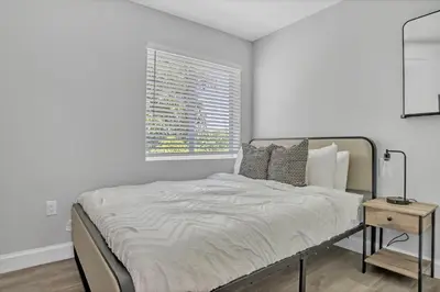a white bedroom with a bed and a window at Sistrunk Shades Villa #5 - New Townhome in Downtown Fort Lauderdale in Fort Lauderdale