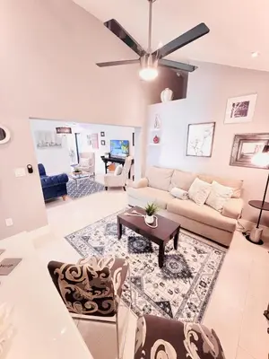 a living room with a couch and a table at Stay Central: Relax in Our Heated Pool Oasis in Miami