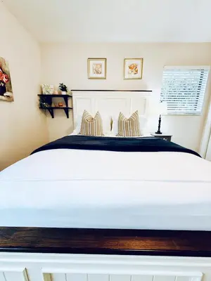 a bedroom with a large white bed with two pillows at Stylish Stay Close to UM City Vibes in Miami