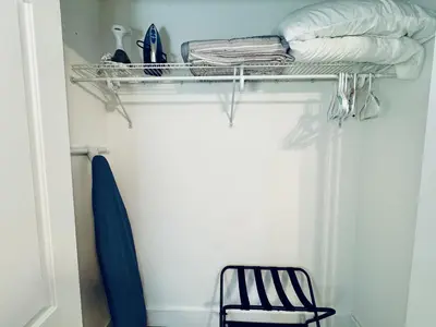 a black chair and a shelf in a room at Stylish Stay Close to UM City Vibes in Miami