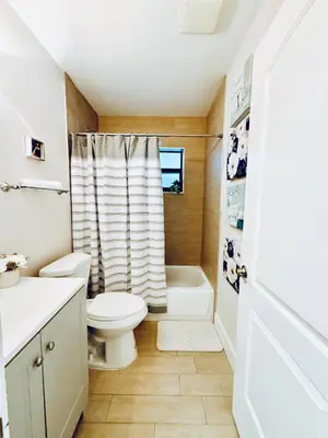 a small bathroom with a toilet and a shower at Stylish Stay Close to UM City Vibes in Miami