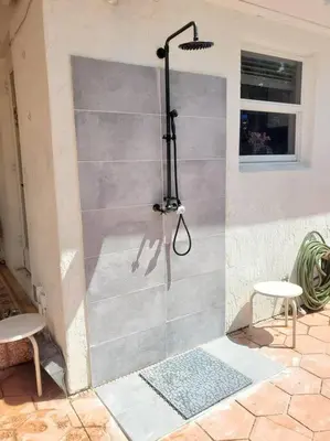 a shower stall in a room with two tables and a window at Pool Paradise Half mile to Beach w Massive Yard! in Hollywood