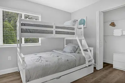 a white bunk bed in a white room with a window at Sistrunk Shades Entire Compound 5 Homes 50 Guests in Fort Lauderdale