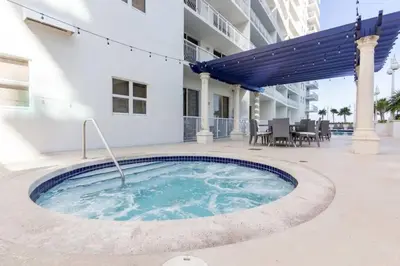 a hot tub in the courtyard of a building at Glam Studio: Sleeps 4 x Pool x Gym x Parking in Miami