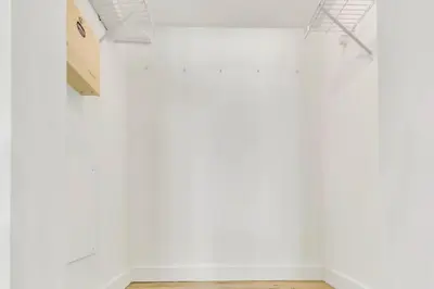 an empty room with white walls and a wooden floor at Glam Studio: Sleeps 4 x Pool x Gym x Parking in Miami