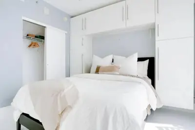 a white bedroom with a bed with white walls at Chic Penthouse: 3BR x Pool x Gym x 2 Parking Spots in Miami