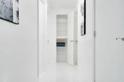 a room with a white door and some pictures at Chic Penthouse: 3BR x Pool x Gym x 2 Parking Spots in Miami