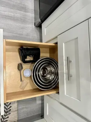 a cupboard with a kitchen utensils in it at Oasis in Plantation South Florida in Plantation