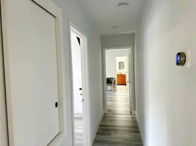 a hallway with white walls and a white door at Oasis in Plantation South Florida in Plantation