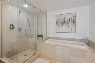 a bathroom with a tub and a glass shower at LUX 2B-2B at ICON - Water View & 5-Star Amenities in Miami