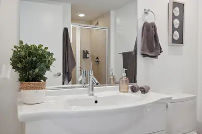 a white bathroom sink with a potted plant on it at LUX 2B-2B at ICON - Water View & 5-Star Amenities in Miami