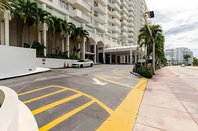 a car parked in a parking lot in front of a building at Pavilion - Best ocean sunrise-Miami Beach in Miami Beach