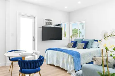 a bedroom with a bed and a table and chairs at 316 Seascape Unit 2 in Hollywood