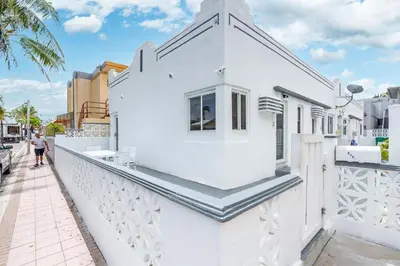 a white house with stairs on a balcony at 316 Seascape Unit 2 in Hollywood