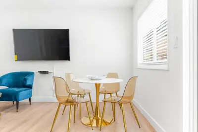 a dining room with a table and chairs and a tv at 316 Footloose #3 in Hollywood