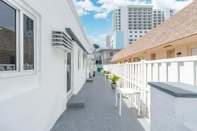 a balcony of a white building with benches on it at 316 Footloose #3 in Hollywood