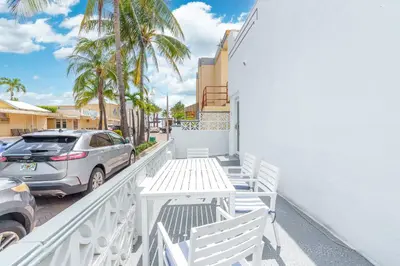 a balcony with white chairs and a car at 316 Footloose #1 in Hollywood