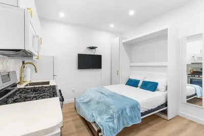 a small bedroom with a bed and a stove at 316 Footloose #1 in Hollywood