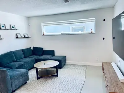 a living room with a blue couch and a table at Designer Pool & Family Dream Home in Hollywood