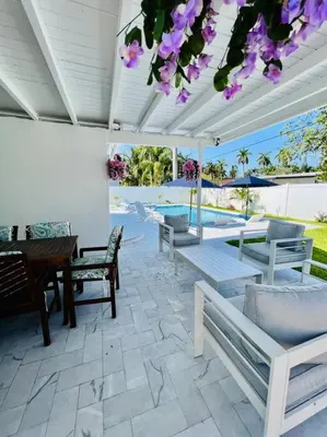 a patio with benches and a table and a pool at Designer Pool & Family Dream Home in Hollywood