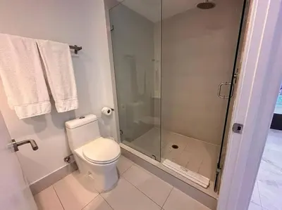 a bathroom with a toilet and a glass shower at 3Bed/2Bath Hallandale Beach in Hallandale Beach