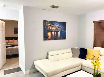 a living room with a couch and a painting on the wall at GREAT LOCATION Downtown/Airport/South Beach in Miami