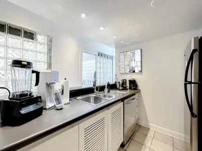 a kitchen with a sink and a counter top at CasaGrandeSouthBeach by AmericanVacationLiving 4RM in Miami Beach