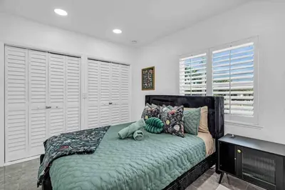 a bedroom with a bed with a teddy bear on it at Miami Luxury Home! Next to Miami airport and beach in Miami