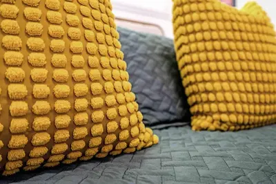 two yellow pillows are sitting on a bed at Miami Cozy Home! Next to Miami beach & Airport in Miami