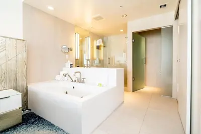 a white bathroom with a tub and a sink at High Floor Luxury 2BR 2BA, Sleeps 6, Resort Access - Horizon by HomeStakes Stays in Fort Lauderdale