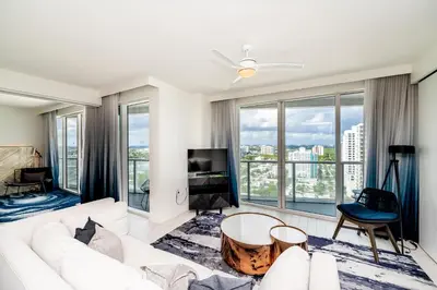 a living room with a white couch and large windows at High Floor Luxury 2BR 2BA, Sleeps 6, Resort Access - Horizon by HomeStakes Stays in Fort Lauderdale