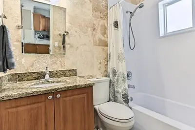 a bathroom with a toilet and a sink and a shower at Wiltonplex B in Fort Lauderdale