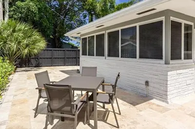 a patio with a table and chairs and a building at Wiltonplex C in Fort Lauderdale