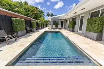 a swimming pool in front of a house at Wiltonplex C in Fort Lauderdale