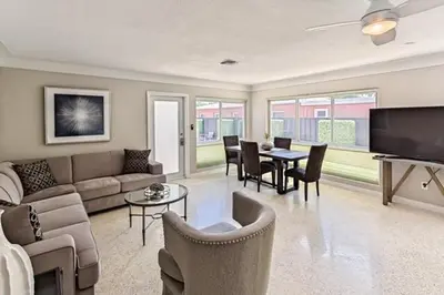 a living room with a couch and a table and chairs at Wiltonplex C in Fort Lauderdale