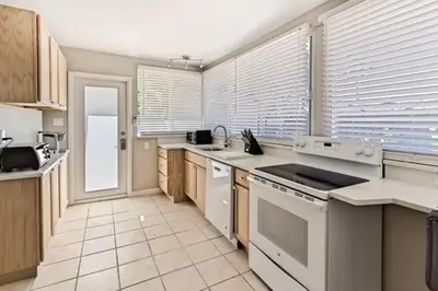 a kitchen with white appliances and wooden cabinets at Wiltonplex D in Fort Lauderdale