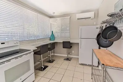 a kitchen with a refrigerator and a table with chairs at Wiltonplex D in Fort Lauderdale