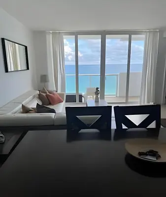 a living room with a bed and a large window at Pavilion - Great ocean view -Miami Beach in Miami Beach