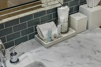 a bathroom with a sink with towels on a counter at Gorgeous Partial Ocean View I The Ritz Carlton in Miami