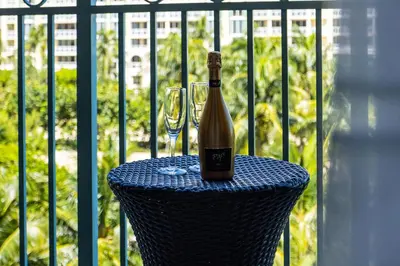 a bottle of wine sitting on a table with a glass at Gorgeous Partial Ocean View I The Ritz Carlton in Miami