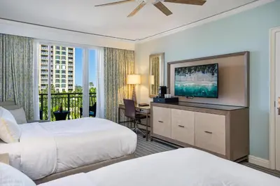 a hotel room with two beds and a flat screen tv at Gorgeous Partial Ocean View I The Ritz Carlton in Miami