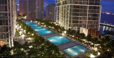 a row of pools in a city at night at Gorgeous Bay & City view condo in Brickell with Free SPA in Miami