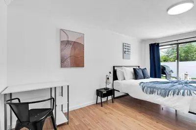 a bedroom with a bed and a desk and a window at Centrally Located 4BDR Pool Home in Miami in Miami Gardens