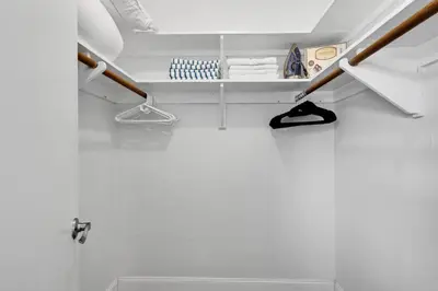 a bathroom with white walls and a shelf with shoes at Centrally Located 4BDR Pool Home in Miami in Miami Gardens