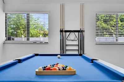 a billiard room with a blue pool table at Centrally Located 4BDR Pool Home in Miami in Miami Gardens