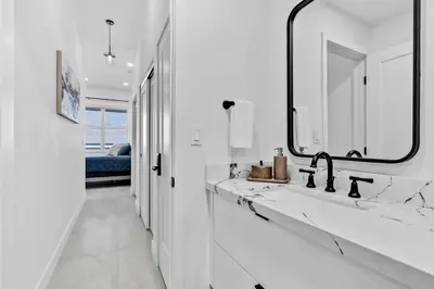 a white bathroom with two sinks and a mirror at OceanFront Luxury Penthouse 2 Bedrooms with Direct Ocean View in Miami Beach