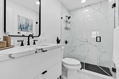 a white bathroom with a shower and a toilet at OceanFront Luxury Penthouse 2 Bedrooms with Direct Ocean View in Miami Beach