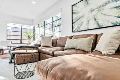 a living room with a couch and a table at Modern Pool Home Great for Families in Hollywood