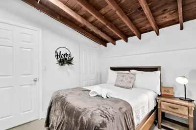 a bedroom with a bed with two towels on it at Modern Pool Home Great for Families in Hollywood